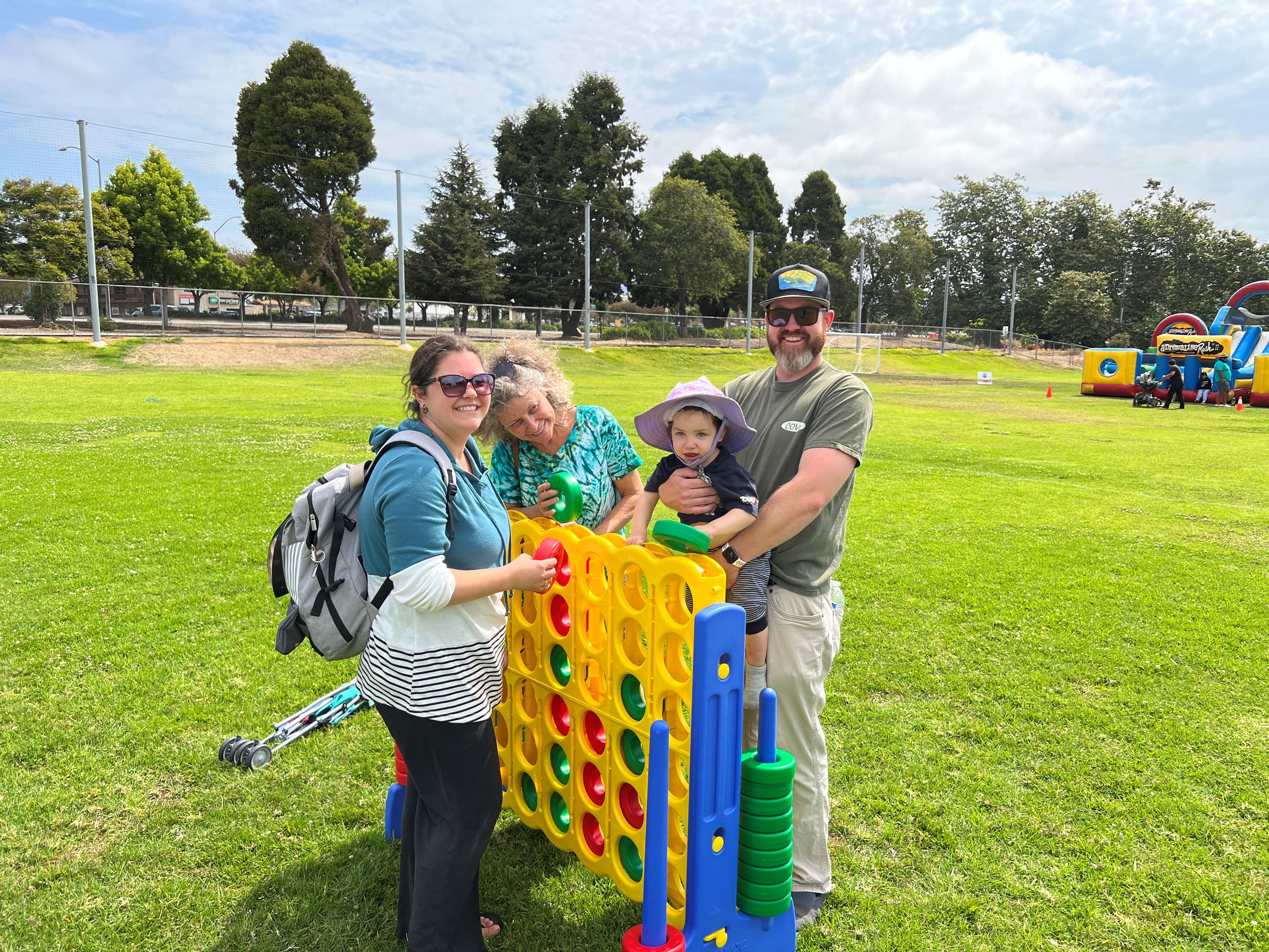 A family playing a giant game of connect four in the park