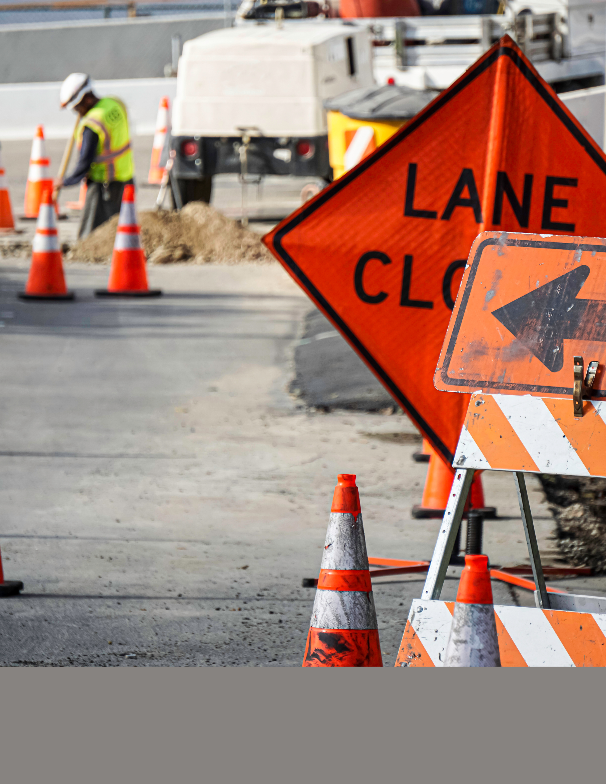Lane Closure Signage with Construction Crews Working in the back 
