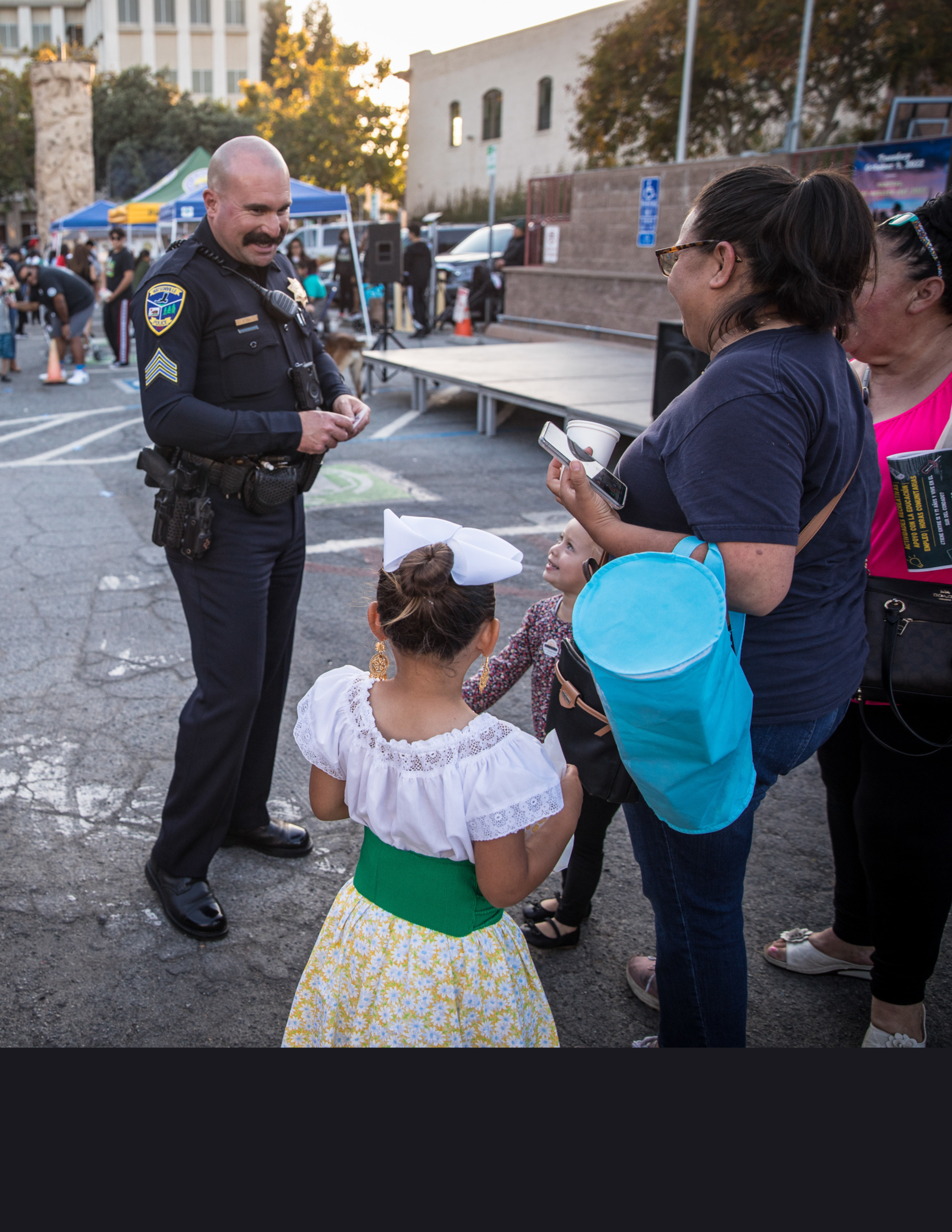 Officer greeting family during community event 