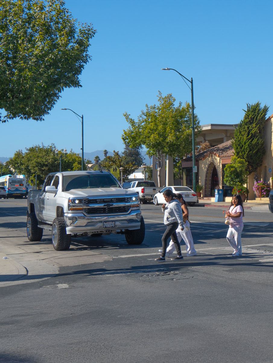 Photo of a mother and daughter crossingMain St. in front of Jalisco's restaurant
