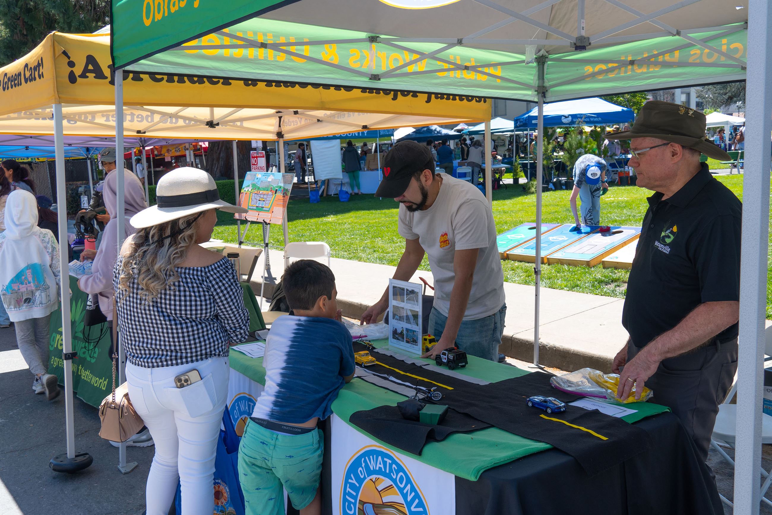 Two engineers explain modifying roads with felt model at Earth Day