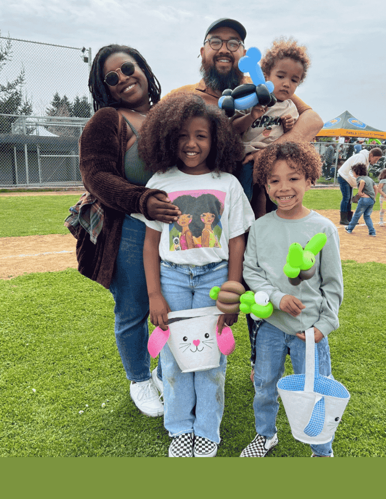 A family with two children holding easter baskets filled with easter eggs 