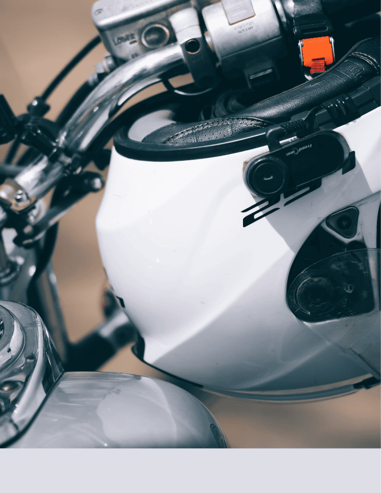 Photo of a helmet hanging on the motorcycle handles