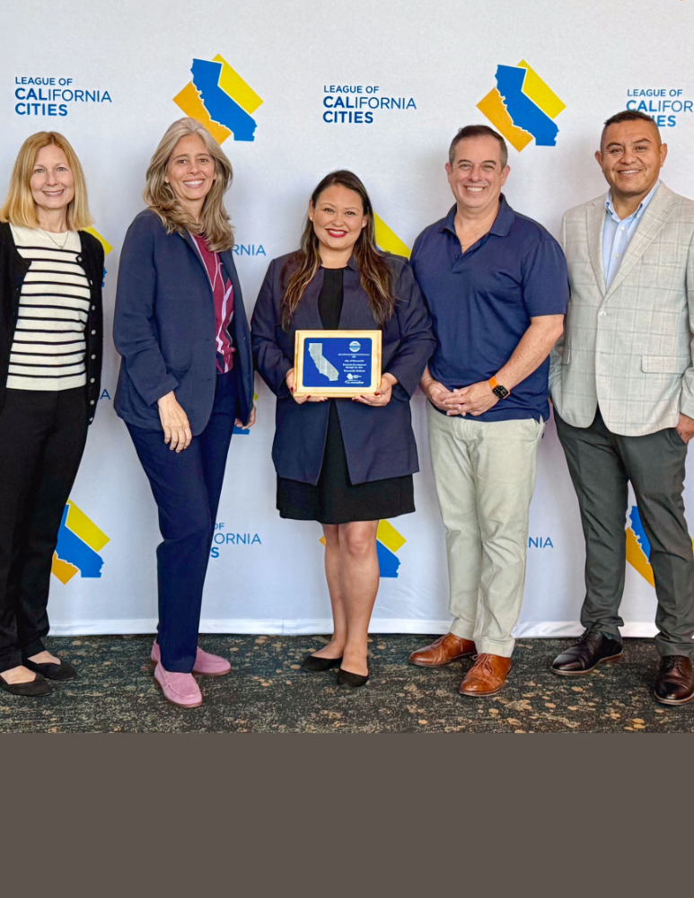 Mayor, Council Members, HR and City Manager posing for a photo with a City award they just won