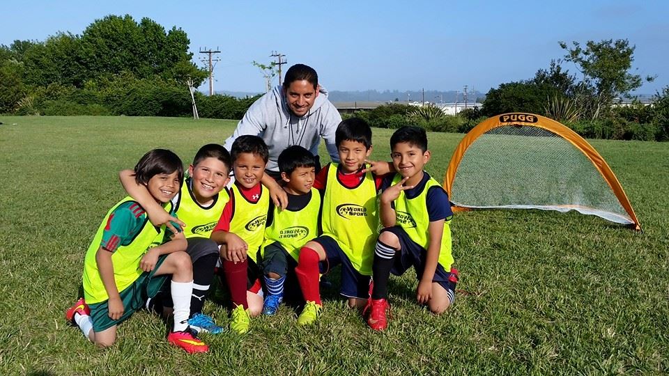 Soccer coach with his youth participants