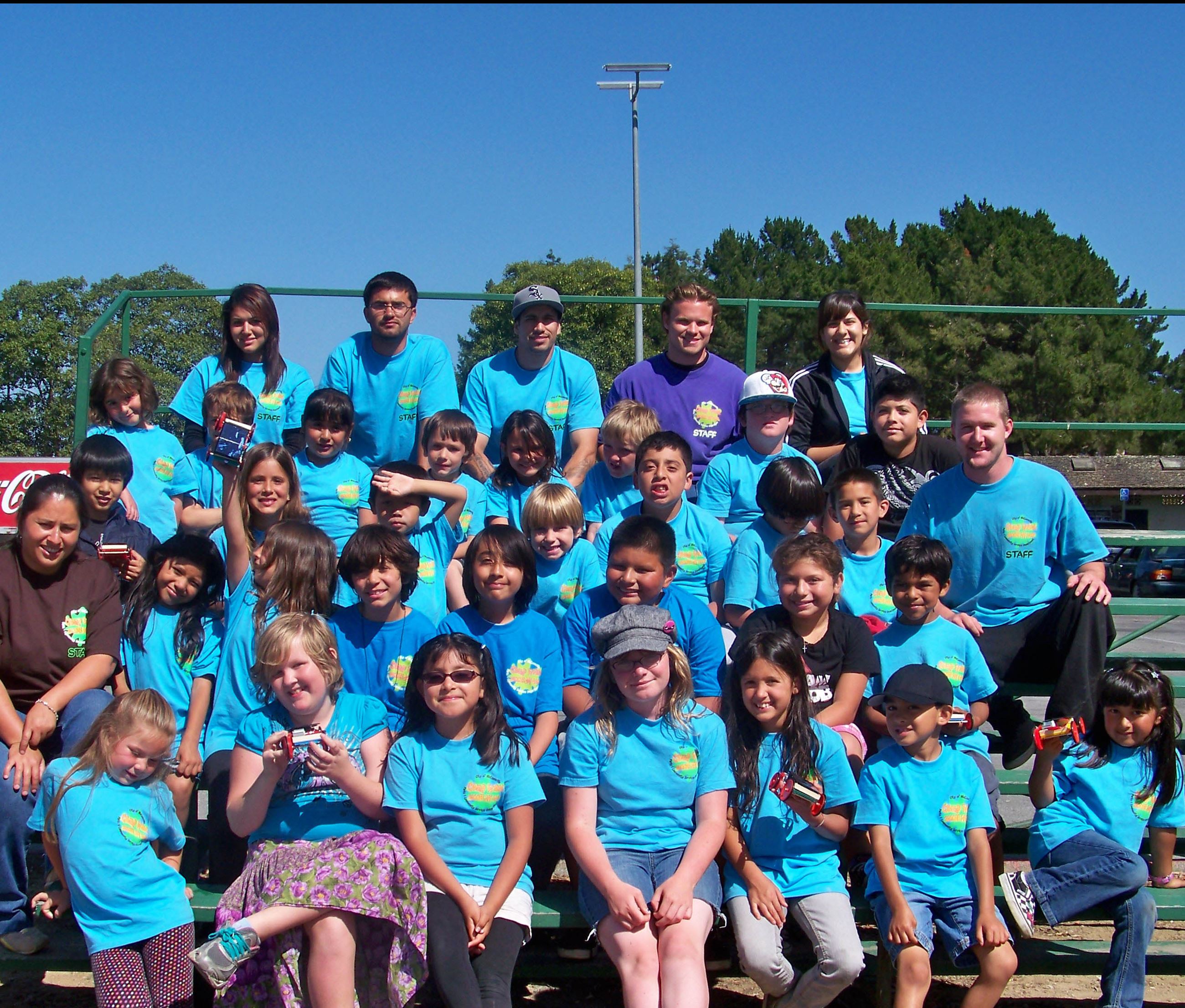 Group of youth and adult participants on bleachers