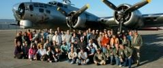 A Group of People in Front of an Old Airplane