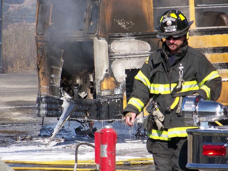 Firefighter and burning school bus