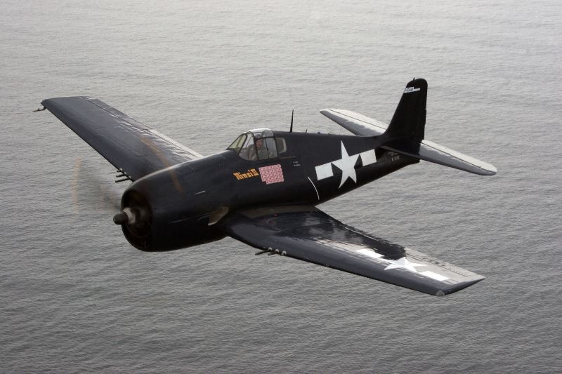 Black Airplane Flying Over Water