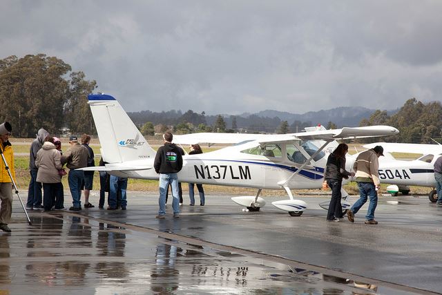 People Looking at Airplane on Runway