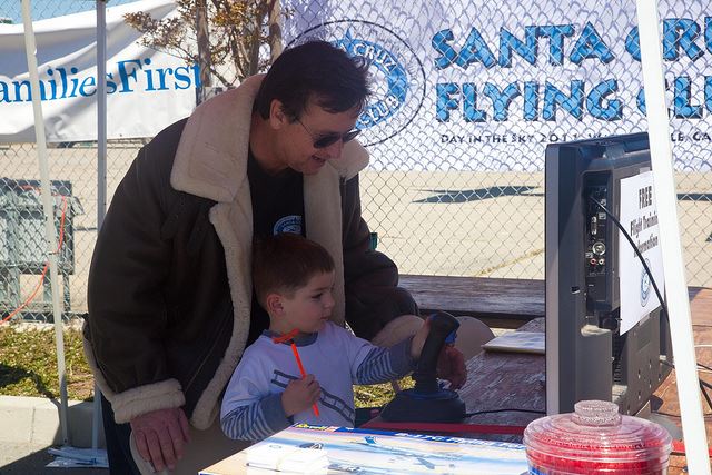 Man Showing Airplane Equipment to Little Boy